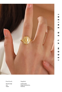 Macro detail of 18K gold-plated heart coin ring with sunray texture and rope band