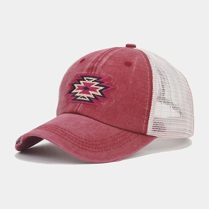 Detail of vintage red distressed cotton cap with mesh back and ethnic embroidery