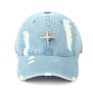 Close-up of distressed light blue denim baseball cap with silver metal star studs
