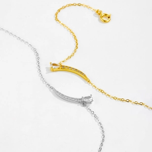 Detailed close-up of S925 silver and gold necklaces with pear-cut zircon pendants