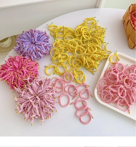 Close-up of colorful braided elastic hair ties with protective plastic seals for kids