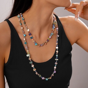Detail of layered bohemian necklace with colorful faux shell and crystal beads
