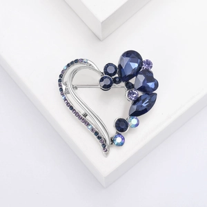Crystal heart brooch with purple and blue diamonds on silver minimalist stand