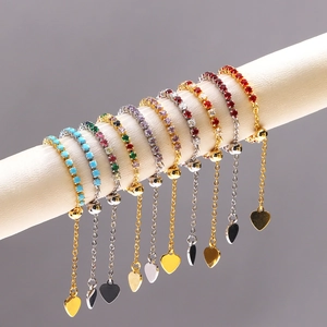 Detail of adjustable zircon bracelets with heart charms on a white display stand
