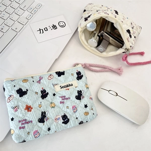 Close-up of quilted floral makeup bags with black cat patterns and rope zip pullers