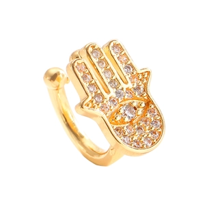 Close-up of golden Hamsa Hand ear cuff with micro-pave cubic zirconia crystals