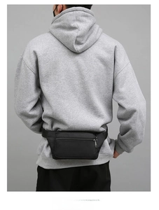 Detail of black durable fabric waist bag shown on model for size and fit perspective