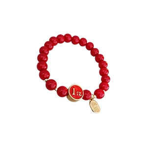 Traditional red beaded bracelet with golden Fu character pendant and lucky charms