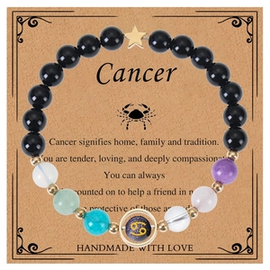 Detail of handmade Cancer zodiac bracelet with natural gemstones on a display card
