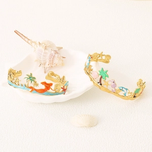 Golden ocean theme open bangles featuring enamel mermaid, seahorse, and palm tree charms