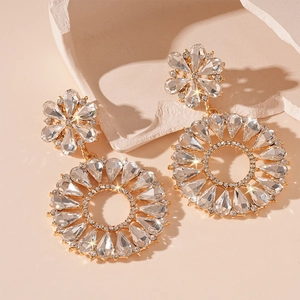 Detailed macro shot of luxury flower statement earrings with gold-toned plating and crystals