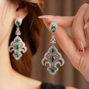 Vintage silver earrings with emerald rhinestones in an elegant royal chandelier style