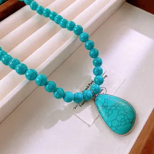 Vintage turquoise beaded necklace featuring a large water-drop pendant with silver frame