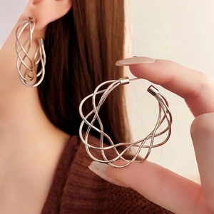 Polished silver hollow twisted C-shape hoop earrings with elegant multi-strand spiral design