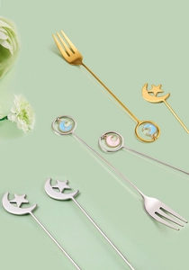 Detailed view of 304 stainless steel moon and star dessert forks and spoons in gold and silver