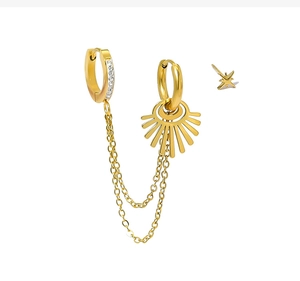 Detail of 18K gold tassel earring with sparkling rhinestones and delicate star stud