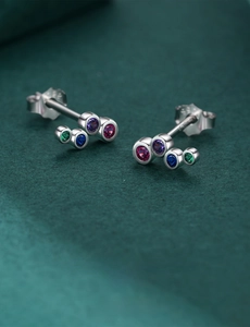 Macro shot of S925 sterling silver rainbow stud earrings with multi-color gems