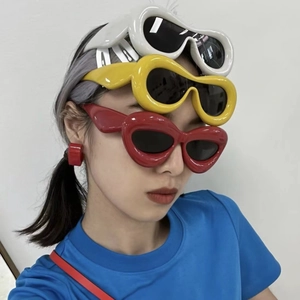 Vertical composition of vintage cat eye sunglasses in red yellow and white frames