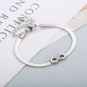 Close-up of silver infinity charm with sparkling crystals on smooth snake chain bracelet
