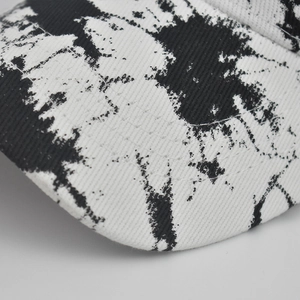 Macro detail of tie-dye cotton visor with reinforced double stitching on the brim