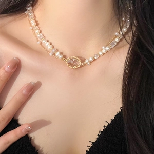 Double-layered necklace with oval crystal pendant, white pearls, and gold-plated chain