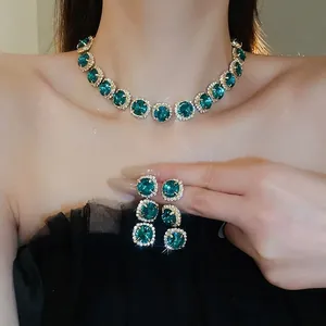 Elegant emerald jewelry set with green circular gemstones and diamond halo necklace with earrings