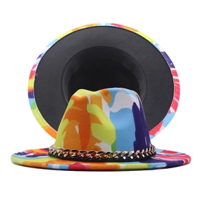 Detail of colorful graffiti fedora hat with gold chain accent and bold color block design