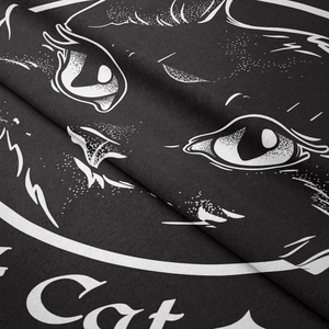 Detailed macro view of the black cat tapestry fabric texture and high-quality white print