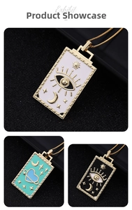 Detail showing rectangular tarot-themed enamel pendants with celestial motifs on gold chains