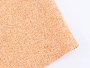 Gros plan sur le tissu en tweed orange montrant la texture des fibres pour gilet sans manches