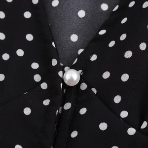 Elegant V-neck polka dot dress with lace trim and decorative pearl button detail