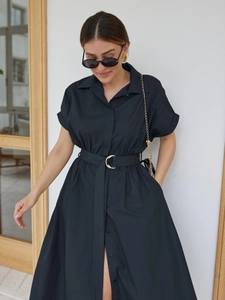 Detail of navy cotton shirt dress featuring a golden crescent belt buckle and side pockets