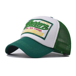 Close-up of Western vintage patch and green mesh detailing on a baseball trucker cap