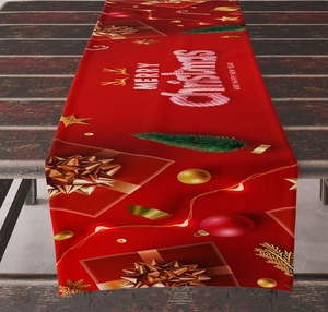 Detail of red Christmas table runner with white Merry Christmas text on wooden table