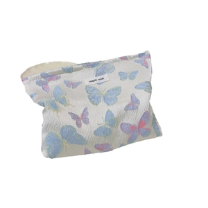 Floral butterfly jacquard makeup bag with zipper closure and brand label on white background