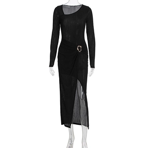 Detailed close-up of a black dress with side gathers and an irregular gold metal buckle