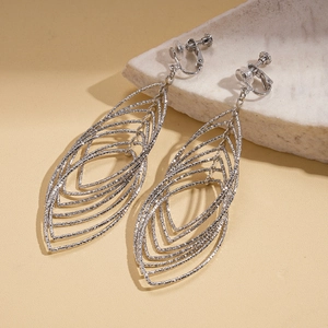 Detailed macro shot of silver layered hollow leaf clip-on earrings with brushed texture