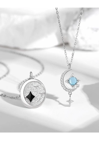 Macro detail of 925 silver star and moon pendants with blue gem and black star insets