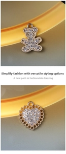 Detail of sparkling rhinestone bear and golden heart alloy charms for DIY jewelry making