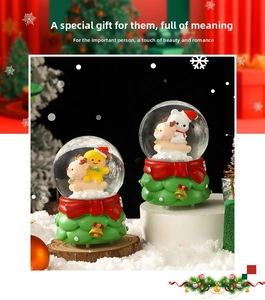 Close-up of festive Christmas crystal balls with deer and tree-textured base decor