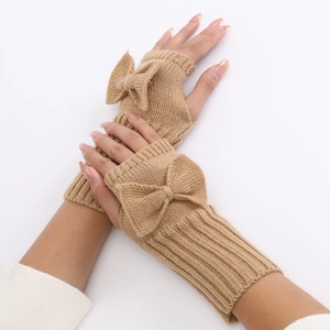 Detail of camel knit fingerless gloves with bow decoration and ribbed wrist cuffs