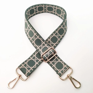Adjustable wide bean green nylon bag strap with white geometric ring pattern and gold clips