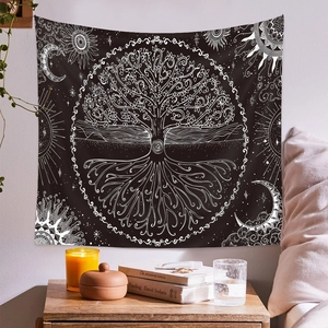 Detail of bohemian tree of life tapestry with celestial sun and moon symbols on bedroom wall