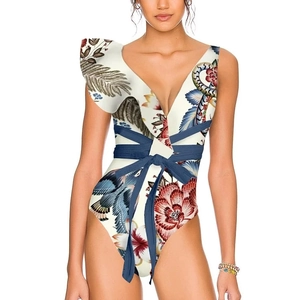 Detail of one-shoulder bikini with ruffle and vintage bird floral print and waist tie