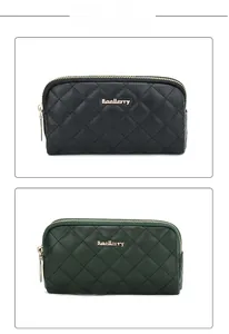 Detail of diamond-quilted leather clutch wallet with dual gold zippers and metal logo