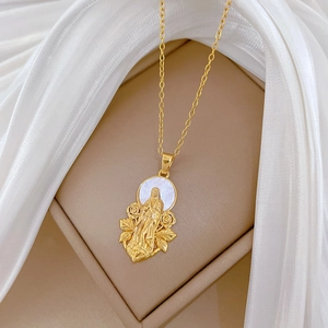 Macro detail of gold flower portrait pendant with shell inlay and crystal necklace