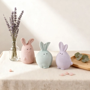 Three cute pastel resin rabbit figurines with a textured matte finish for home decoration