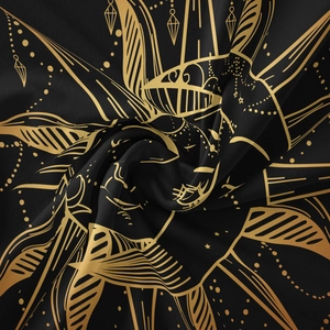 Macro shot of silk-like polyester fabric with golden bohemian sun and mandala pattern