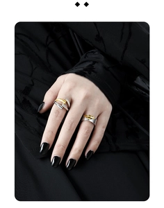Detail of S925 sterling silver rings with gold texture stripes on a model's hand