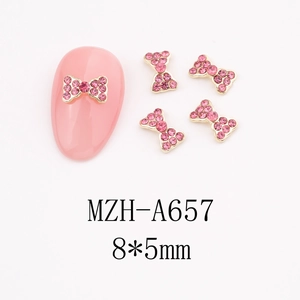 Detail of 8x5mm rose pink bow nail charms with gold alloy base for DIY nail art designs
